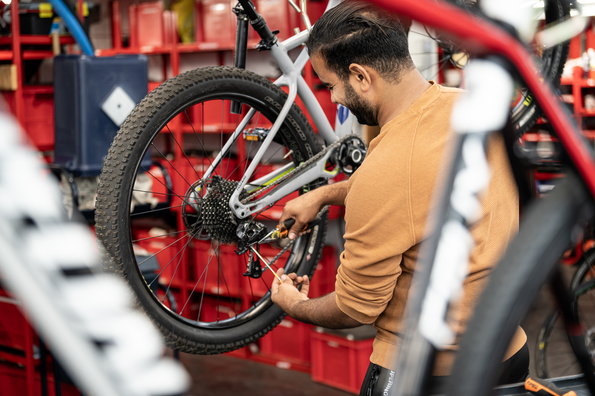 Mécanicien contrôlant un vélo sur un pied d’atelier
